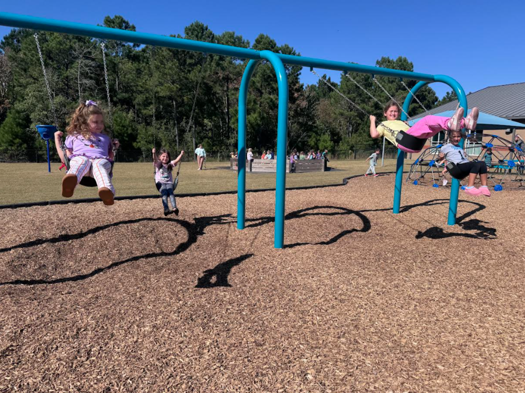 students swinging on swings
