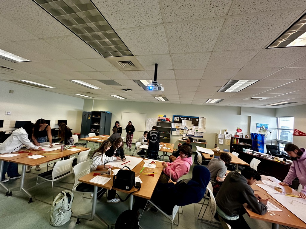 students using wooden skewers to create triangles out of listed dimensions