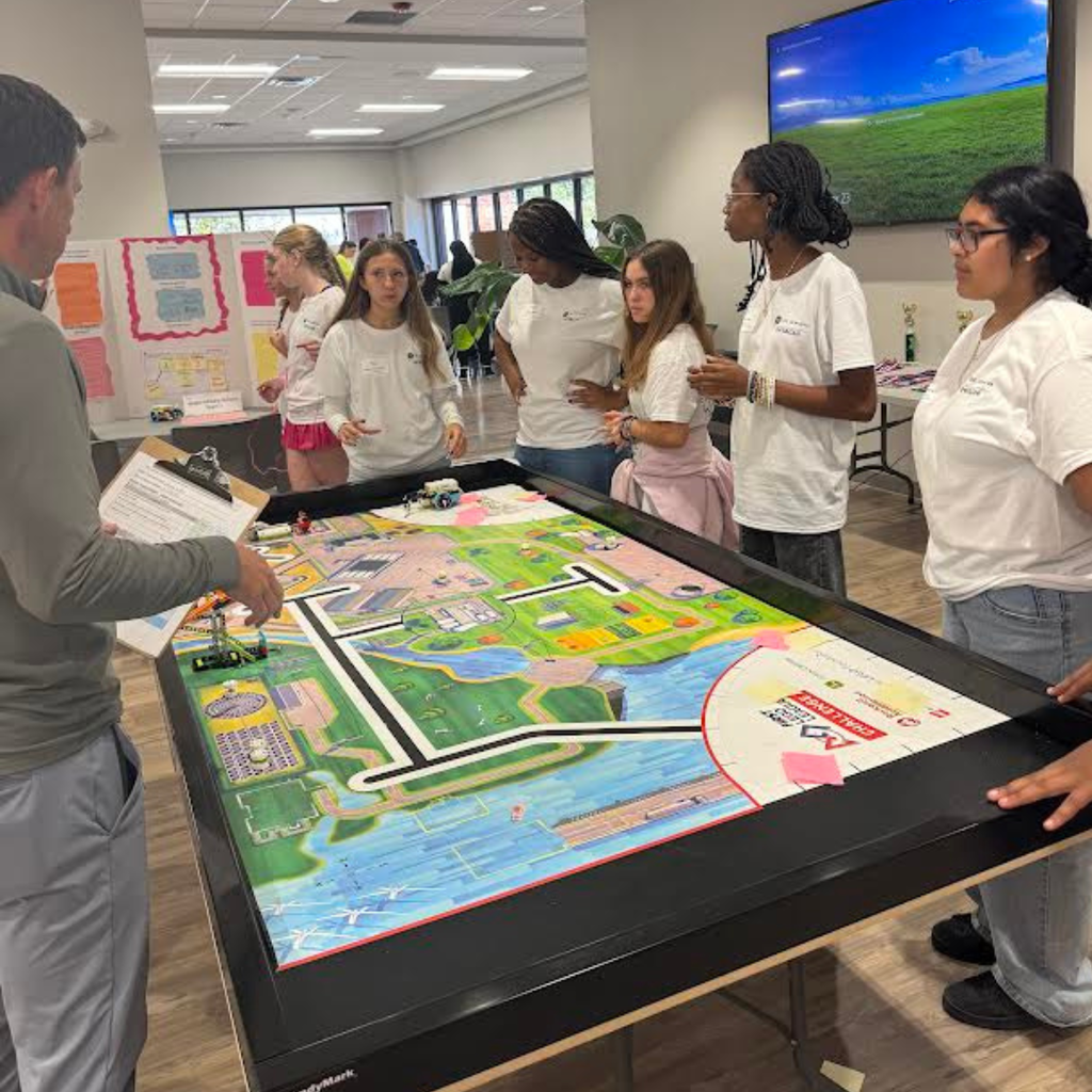 girls in technology trip standing at table