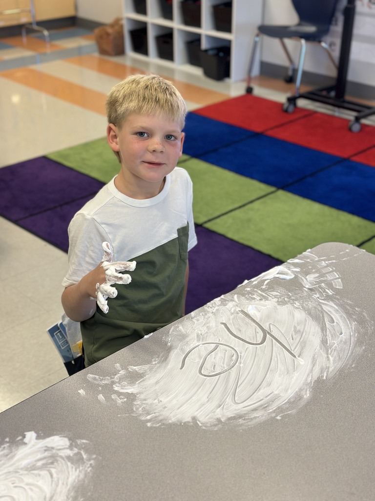 first graders writing their spelling words with shaving cream on their tables