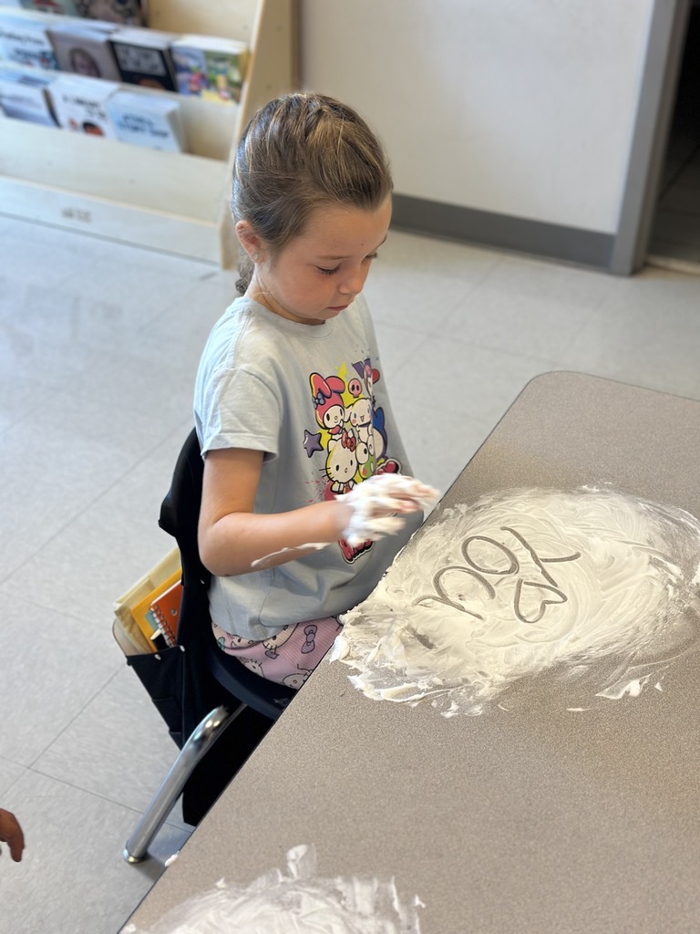 first graders writing their spelling words with shaving cream on their tables