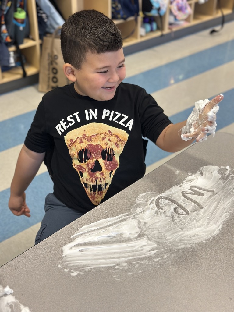 first graders writing their spelling words with shaving cream on their tables
