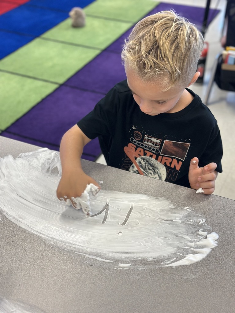 first graders writing their spelling words with shaving cream on their tables