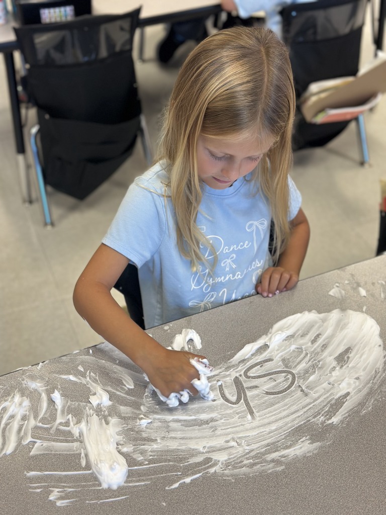 first graders writing their spelling words with shaving cream on their tables