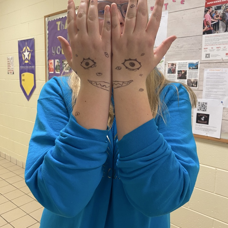pechs student posing with Halloween arm drawings