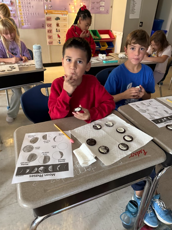 students making moon phases with Oreos
