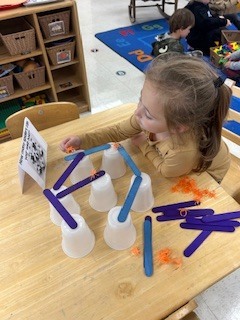 PreK student working on a stem activity