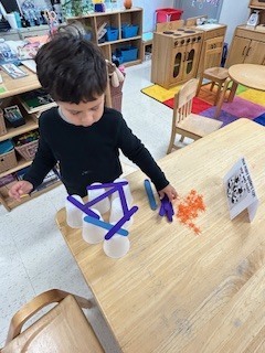 PreK student working on a stem activity