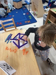 PreK student working on a stem activity