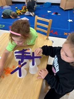 PreK student working on a stem activity