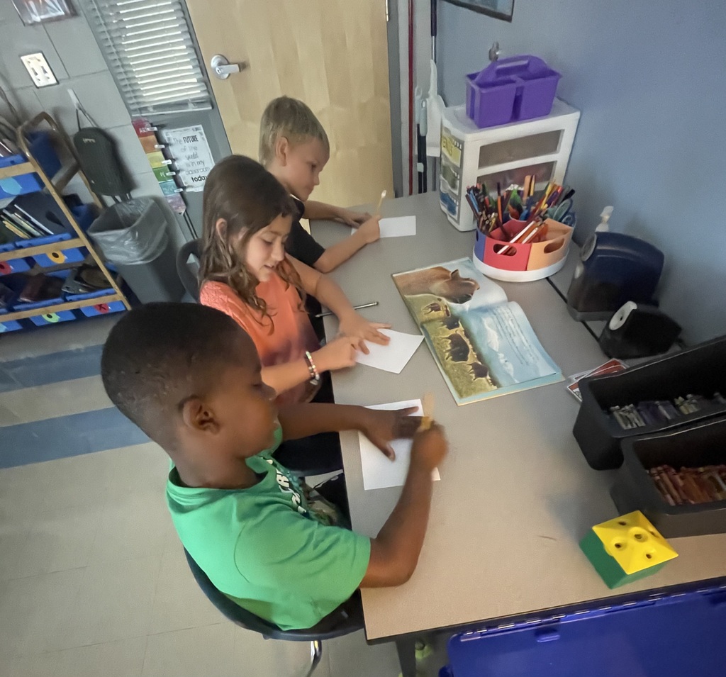 2nd graders working in small groups on a timeline project