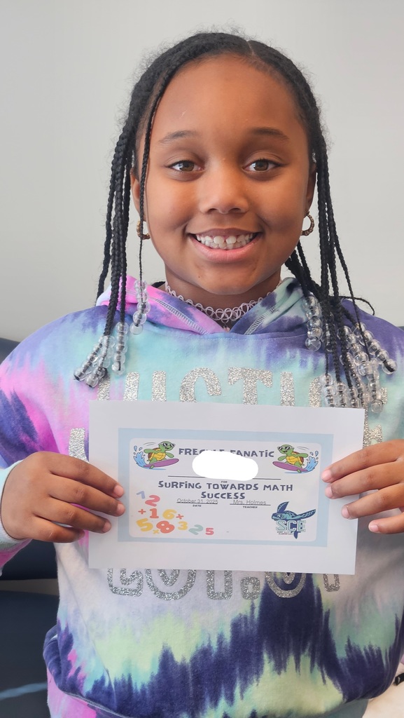 student holding a math certificate
