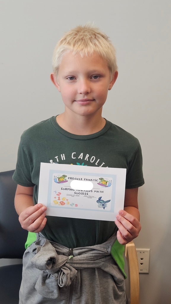 student holding a math certificate