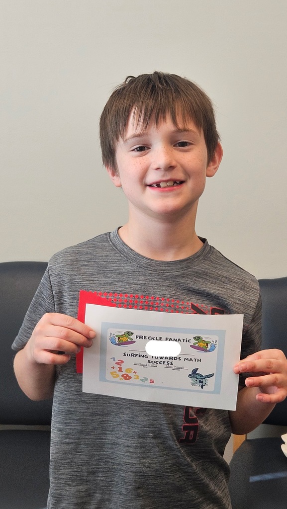 student holding a math certificate