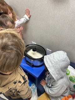 prek students making bread in a crockpot