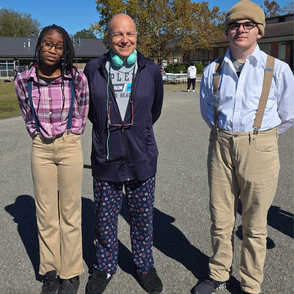 students and teachers posing outside on spirit day