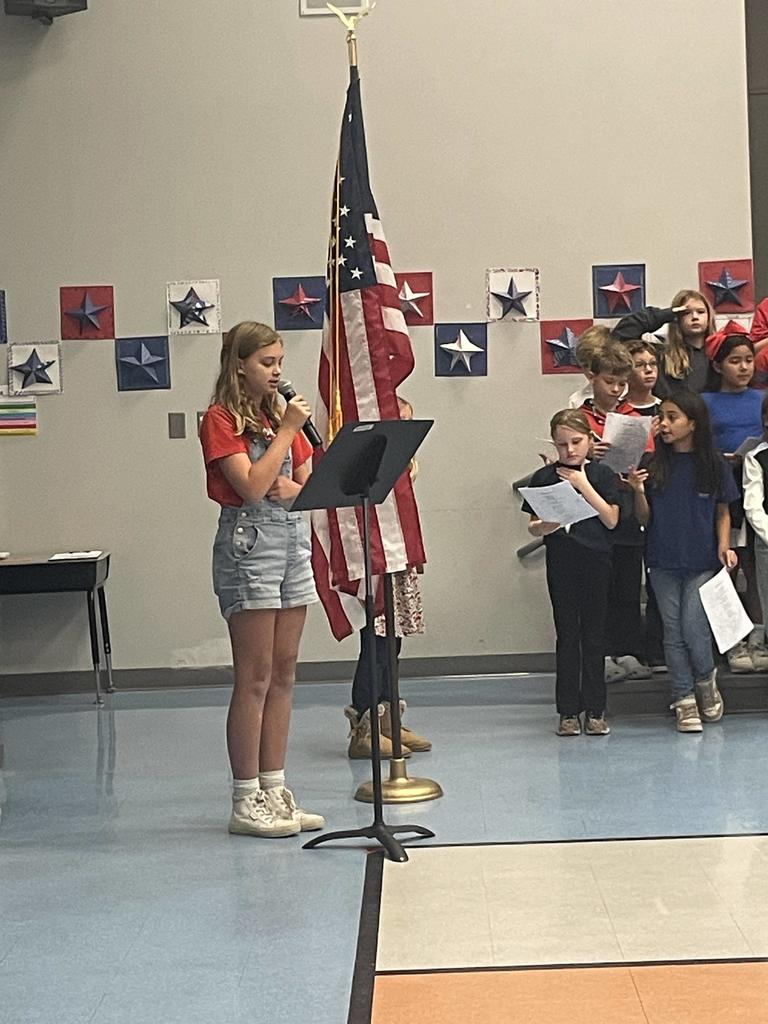 4th grader speaking into a microphone at a concert