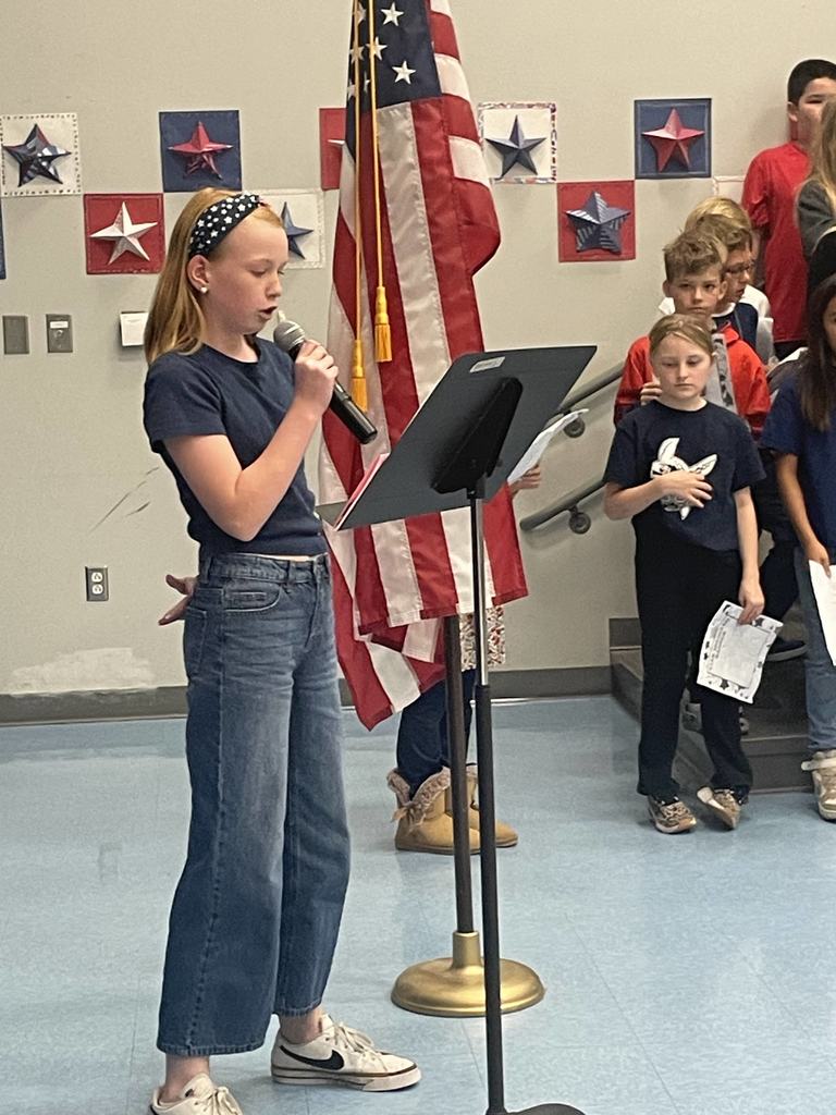 4th grader speaking into a microphone at a concert