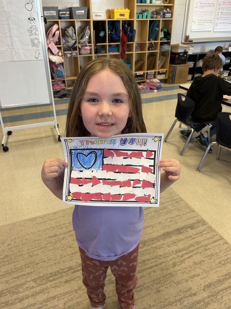 Kindergarten students sitting at their table working on a craft
