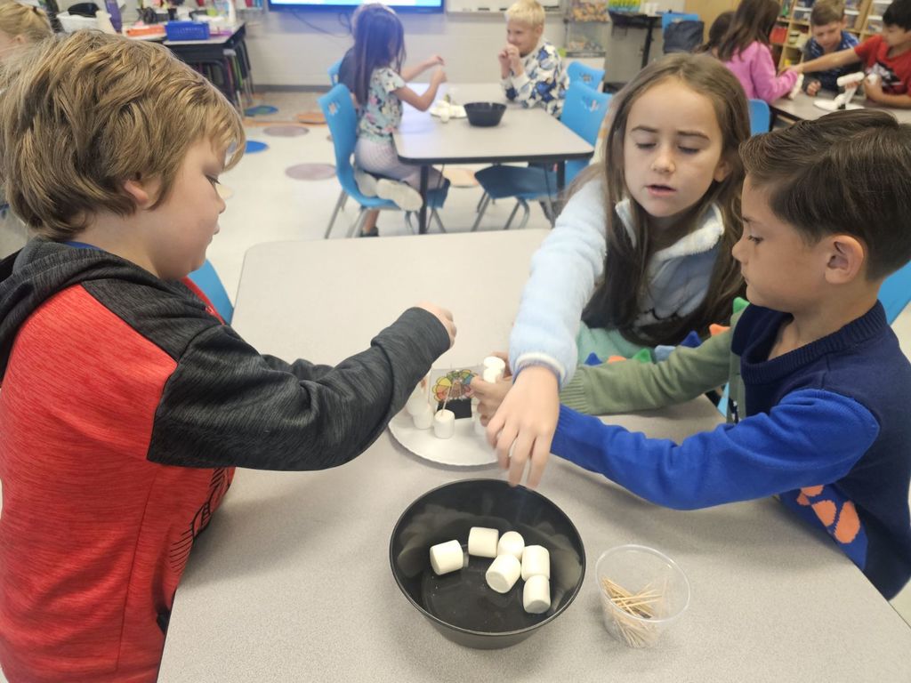 2nd grade students working at their tables on a STEAM project