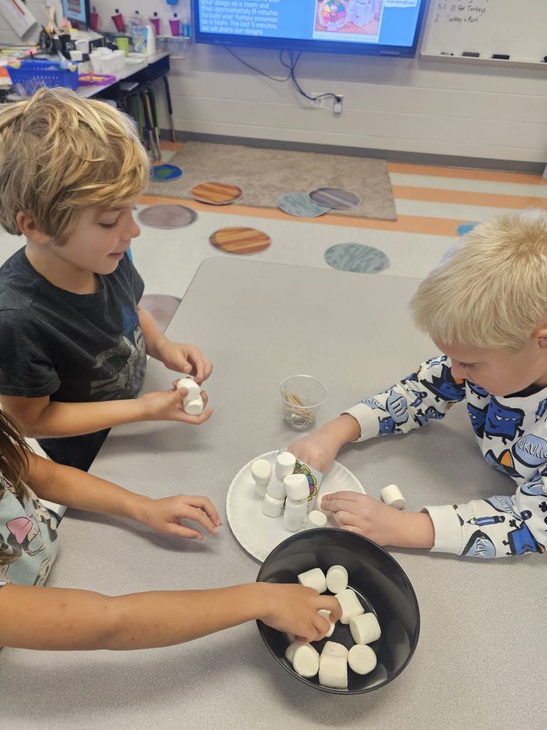 2nd grade students working at their tables on a STEAM project