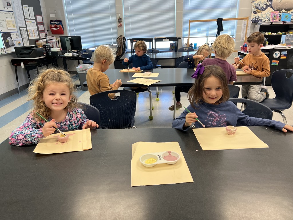 Kindergarten students working at their tables in art class on a clay project