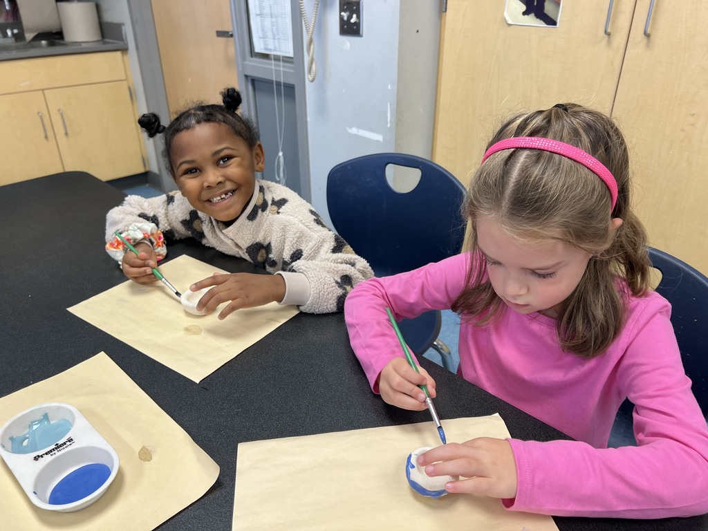 Kindergarten students working at their tables in art class on a clay project