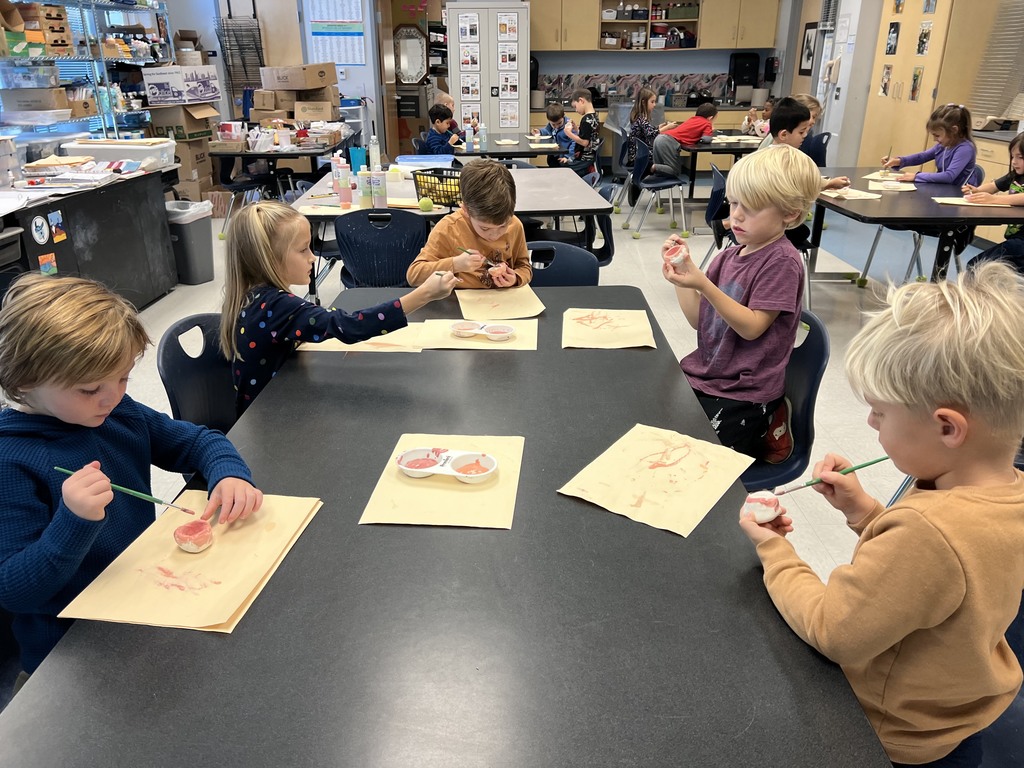 Kindergarten students working at their tables in art class on a clay project