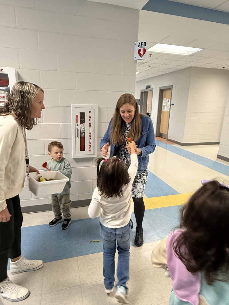 students giving flowers to staff members for world kindness day