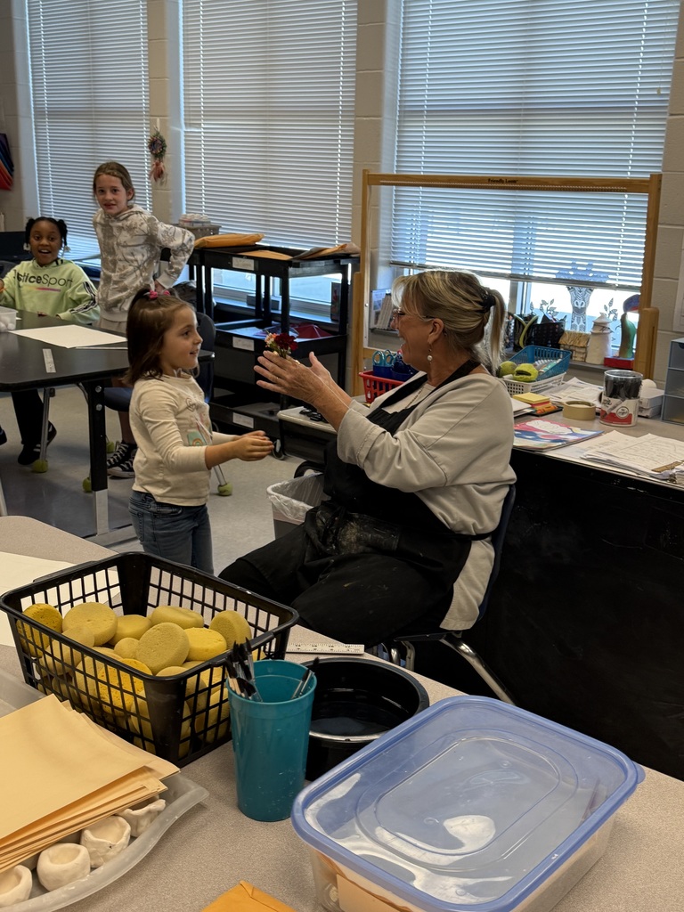 students giving flowers to staff members for world kindness day