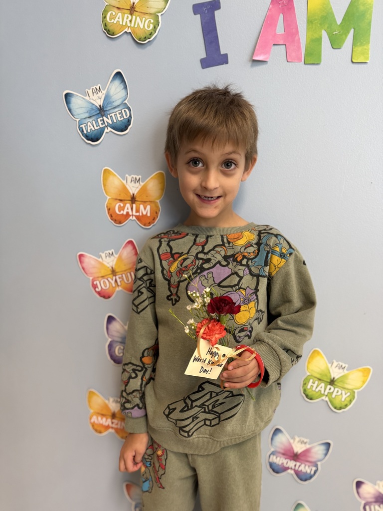 students giving flowers to staff members for world kindness day