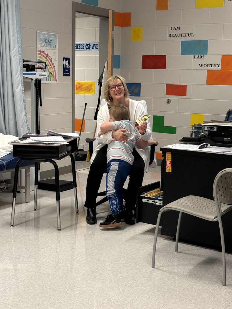 students giving flowers to staff members for world kindness day