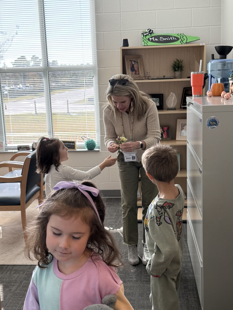 students giving flowers to staff members for world kindness day