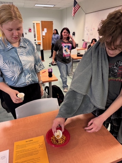 student working on lab by selecting goldfish