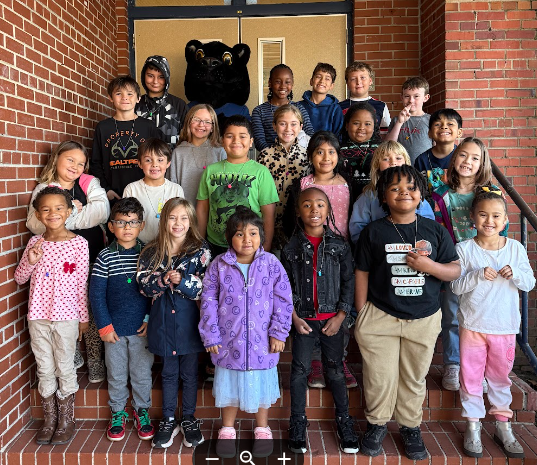 students of the week standing on school steps with the mascot