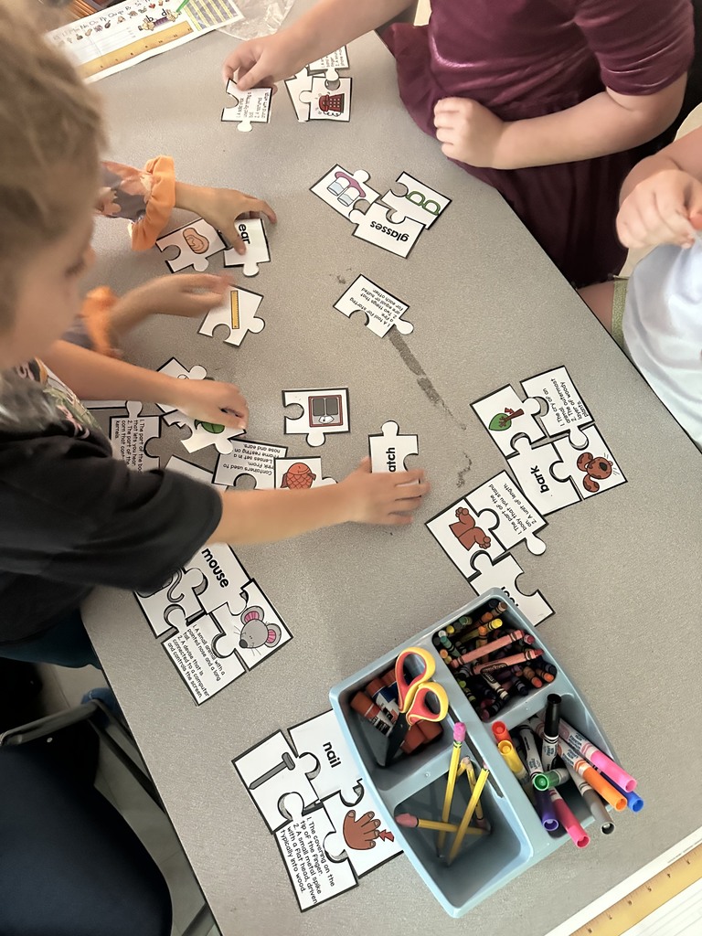 first graders working in groups on a homophone matching activity 