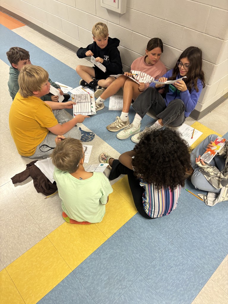 4th grade students working in groups on a writing project