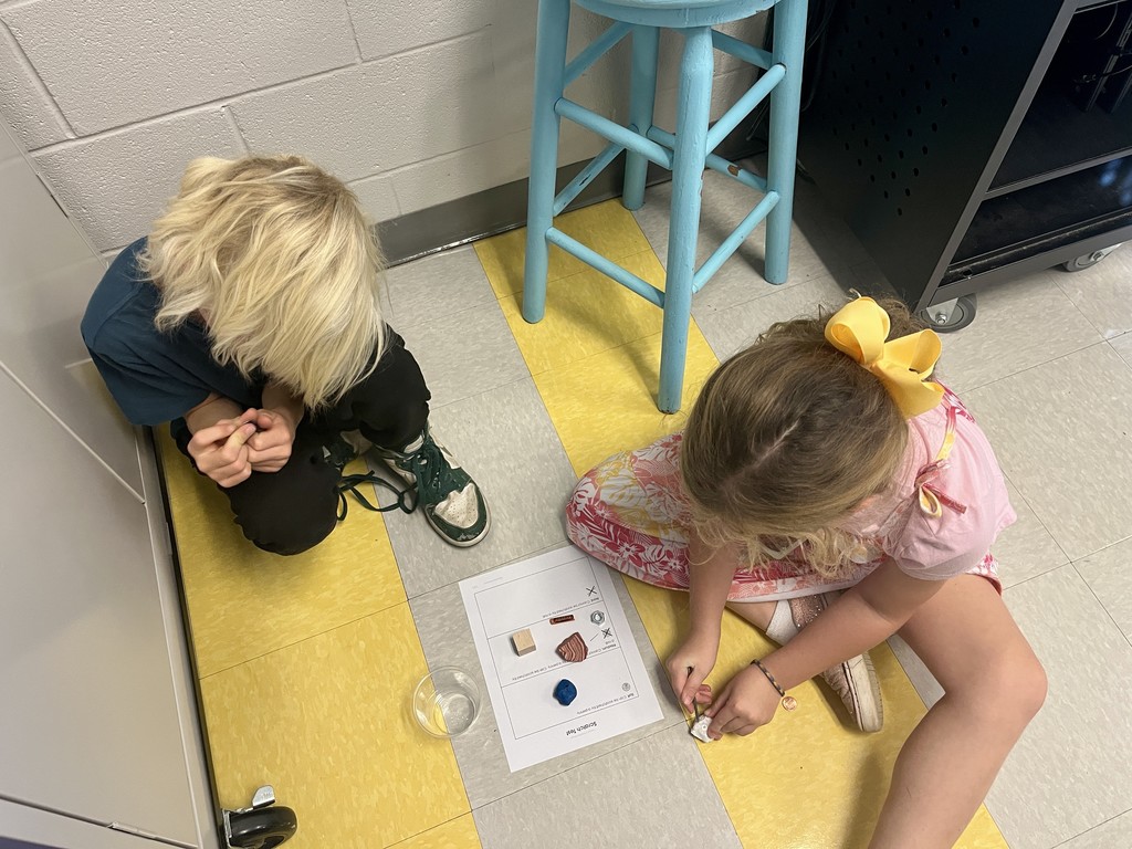 2nd grade students working in groups on a science activity 