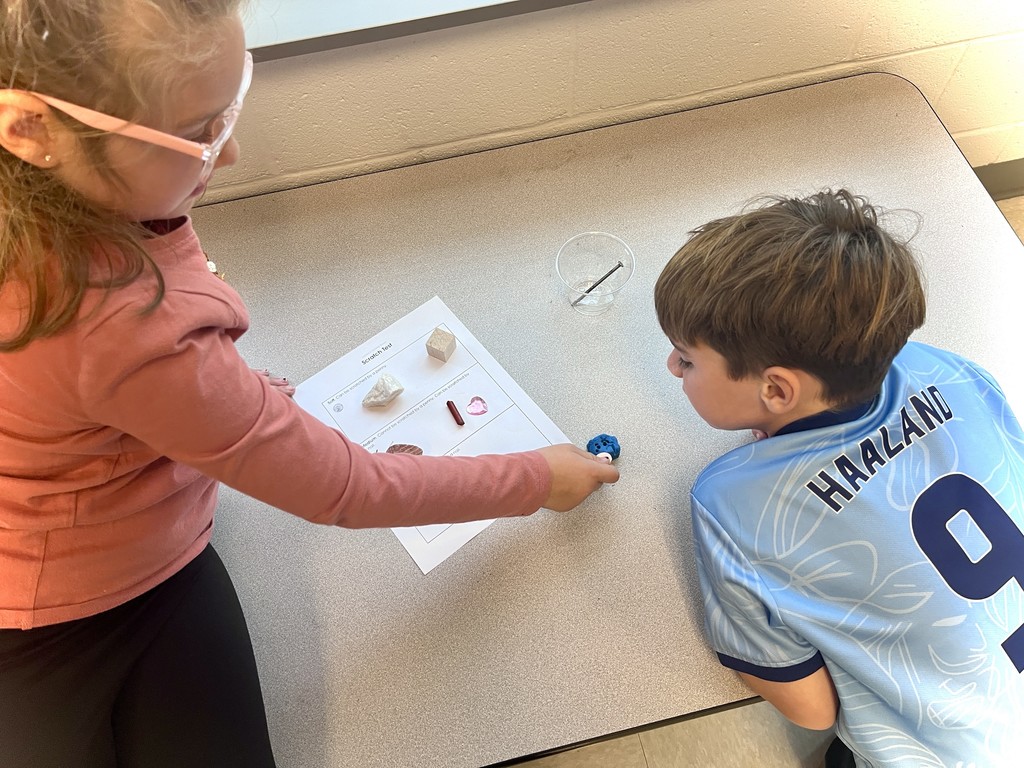 2nd grade students working in groups on a science activity 