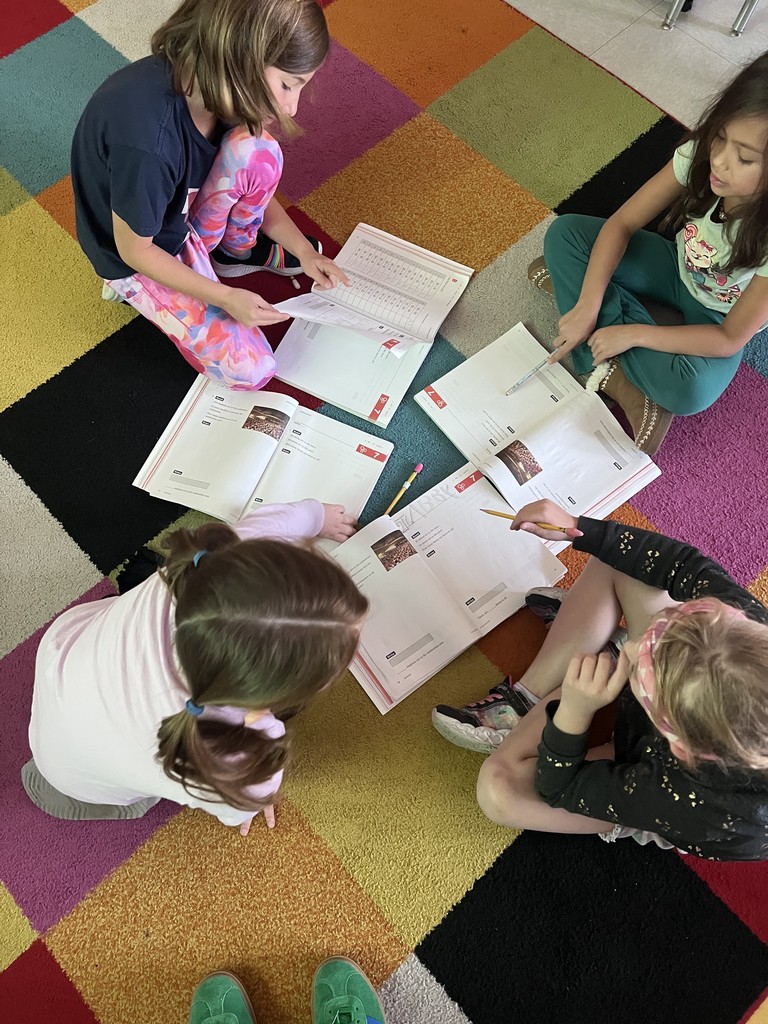 2nd graders working in groups on math problems