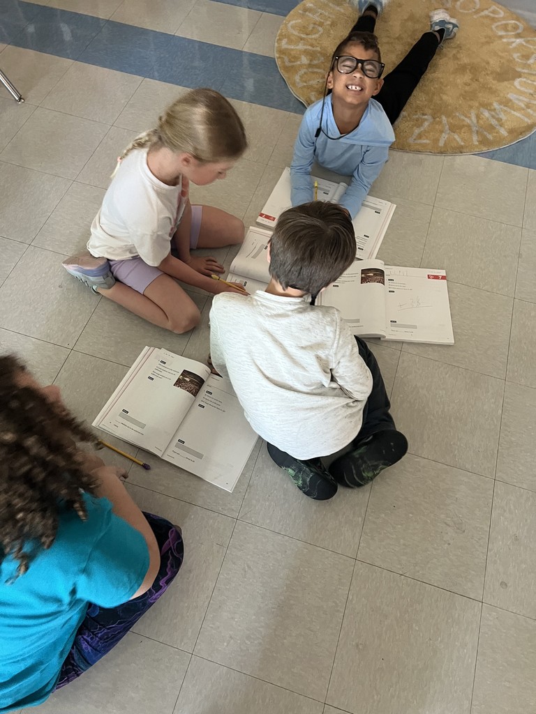 2nd graders working in groups on math problems