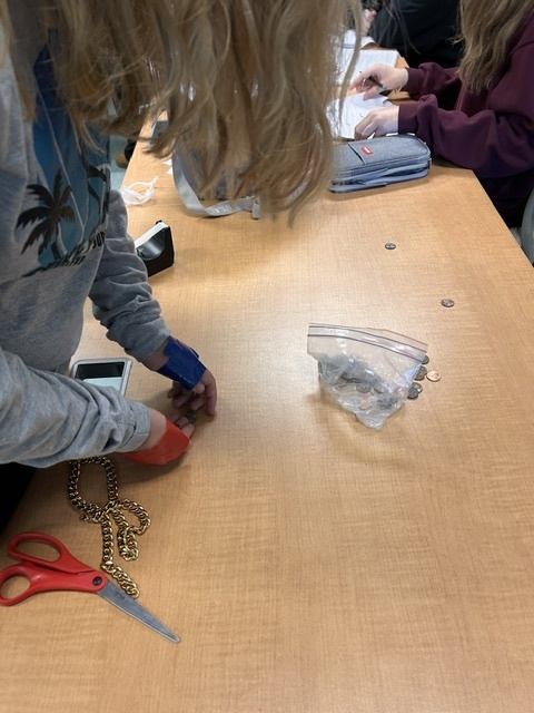 student picks up coins