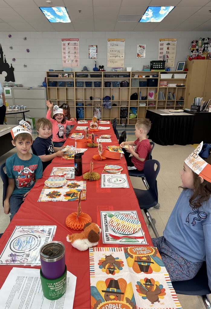 students sitting at a table eating a thanksgiving feast