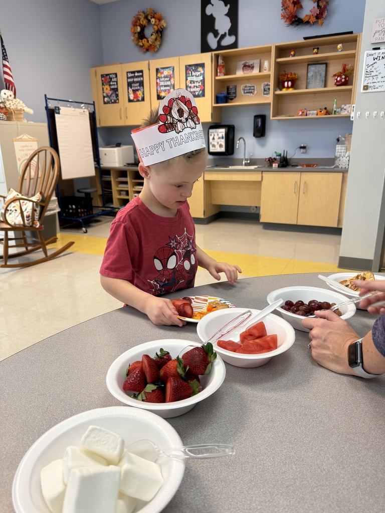 students sitting at a table eating a thanksgiving feast