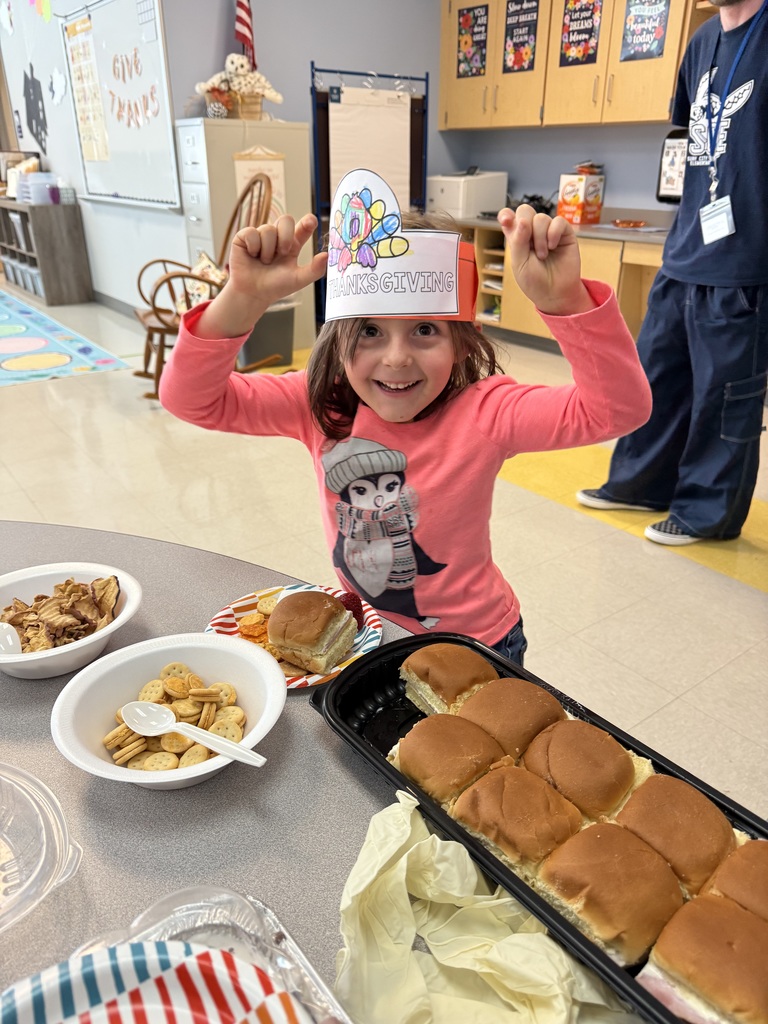 students sitting at a table eating a thanksgiving feast
