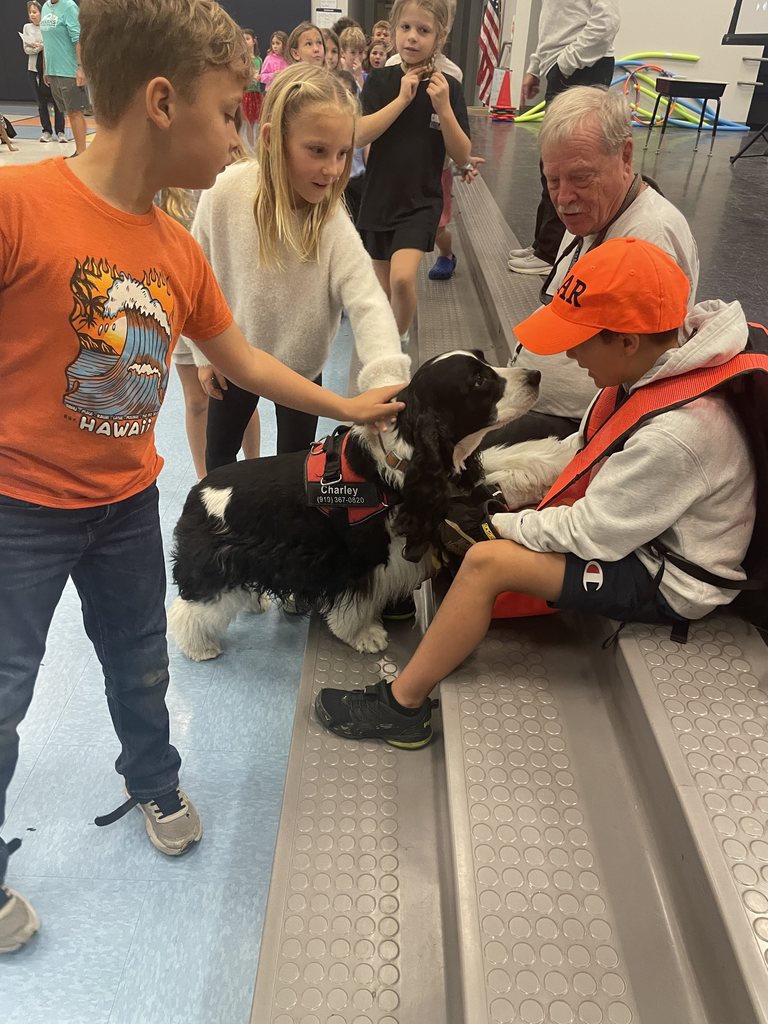 students petting a search and rescue dog