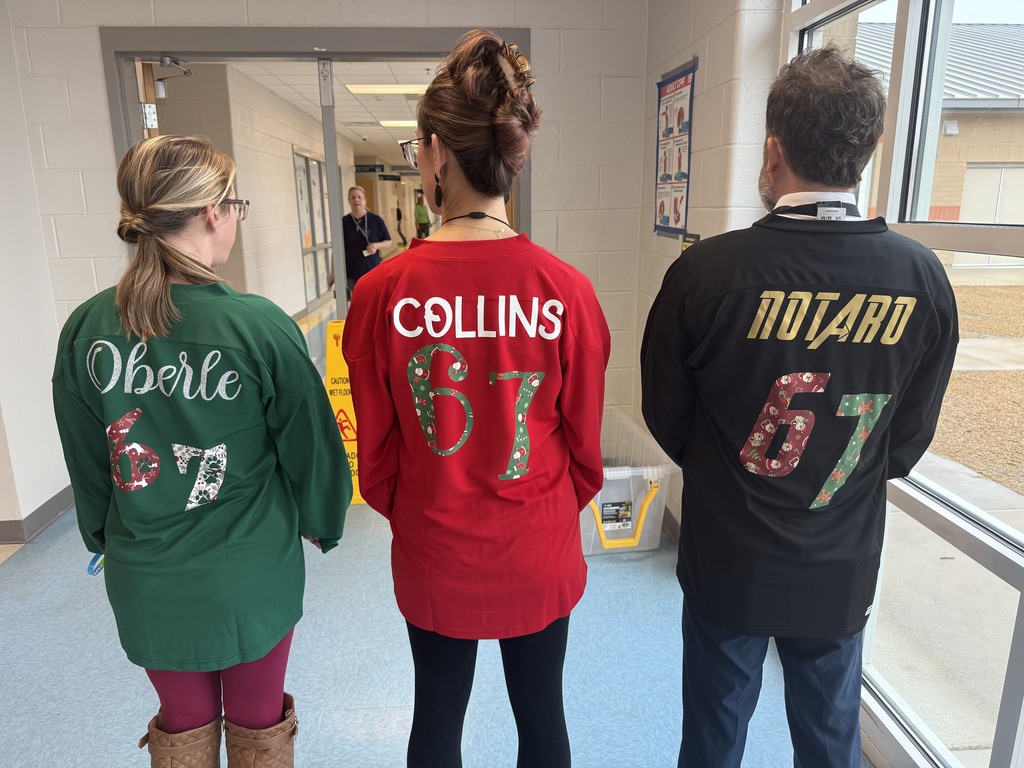 5th grade teachers posing with 6-7 shirts on