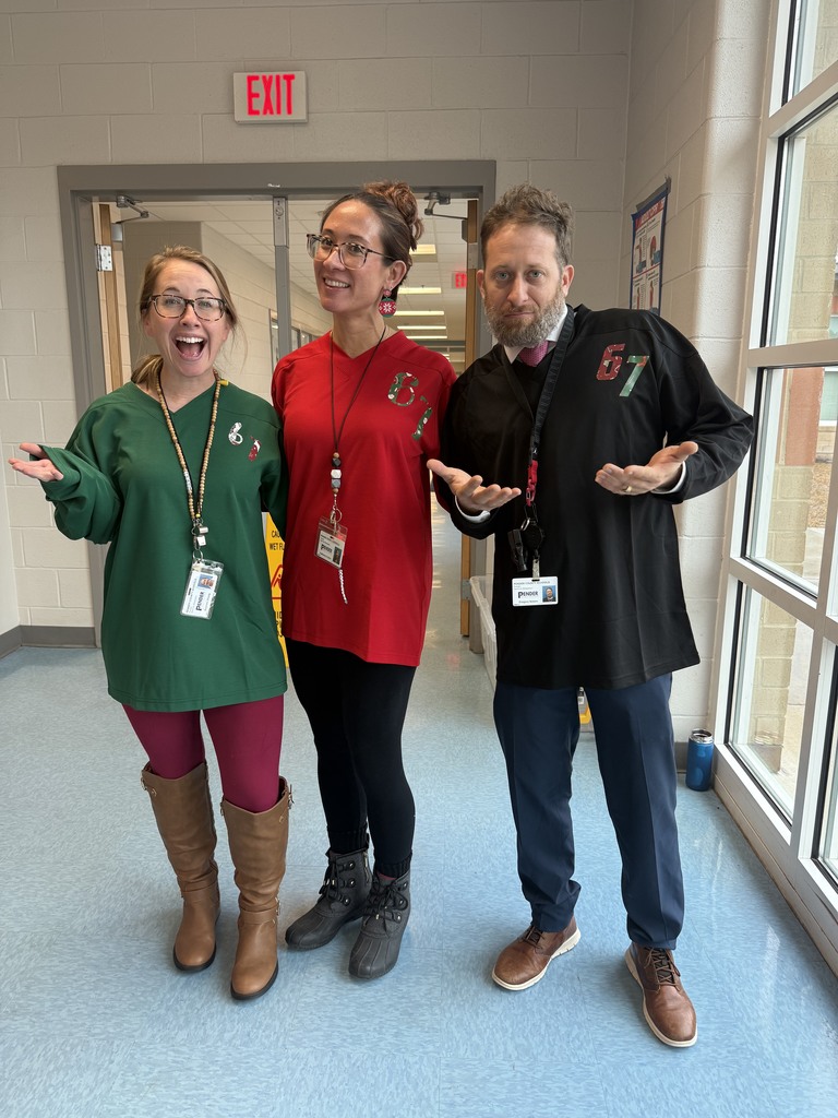 5th grade teachers posing with 6-7 shirts on