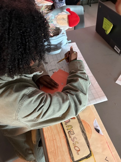 Ms. Patrick's art students using the grid method to enlarge a carton character.