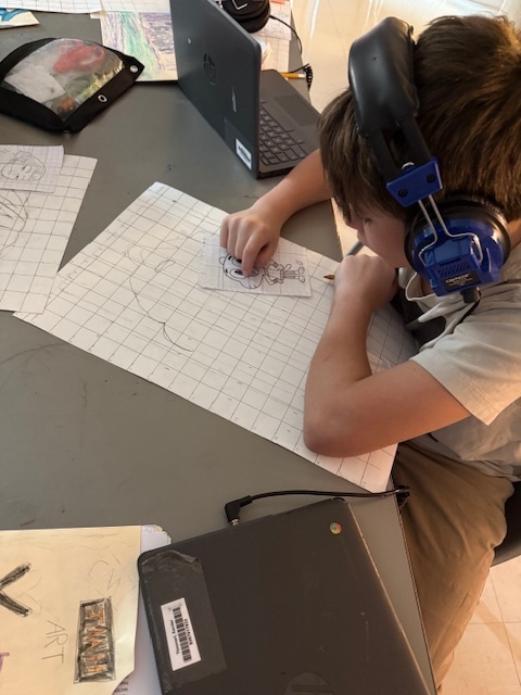 Ms. Patrick's art students using the grid method to enlarge a carton character.